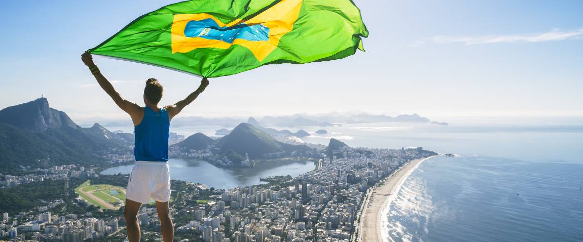 athlete holding brazilian flag